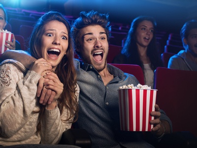 young couple at the movies eating popcorn